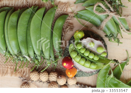 Fresh green peas pod on wood background. Fresh green peas pod on wood background. 33553547