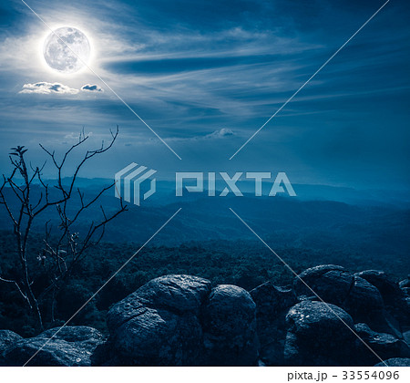 Landscape of rock against blue sky and full moon a 33554096