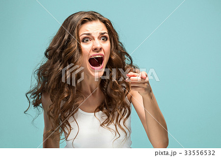 Portrait of young woman with shocked facial 33556532