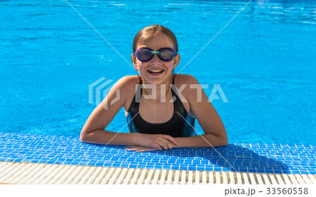 Cute teen girl in swimming pool 33560558