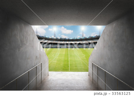 tunnel in stadium with green field 33563125