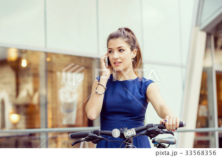 Young woman commuting on bicycle Young woman commuting on bicycle 33568356