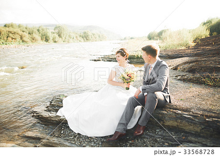 Handsome romantic groom and beautiful bride posing 33568728