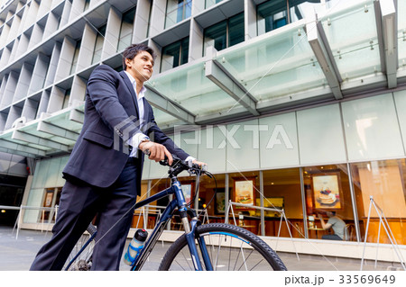Successful businessman riding bicycle 33569649