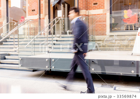 Blurred image of businessman walking Blurred image of businessman walking 33569874