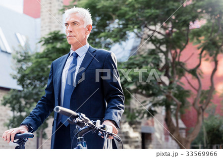 Successful businessman riding bicycle 33569966