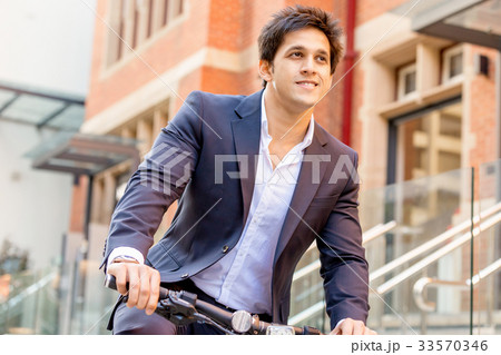 Successful businessman riding bicycle Successful businessman riding bicycle 33570346