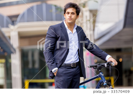 Successful businessman riding bicycle 33570409
