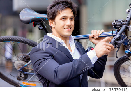 Successful businessman riding bicycle 33570412