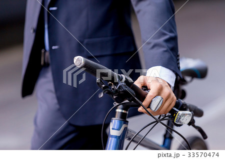 Successful businessman riding bicycle Successful businessman riding bicycle 33570474