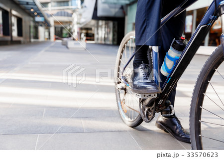 Successful businessman riding bicycle Successful businessman riding bicycle 33570623