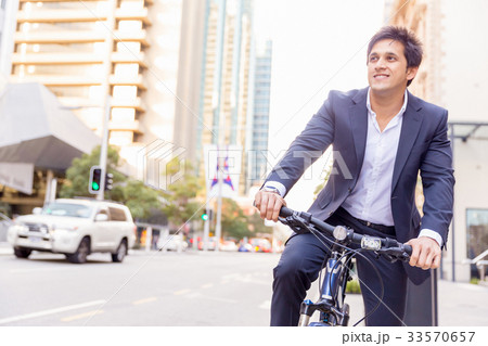Successful businessman riding bicycle 33570657