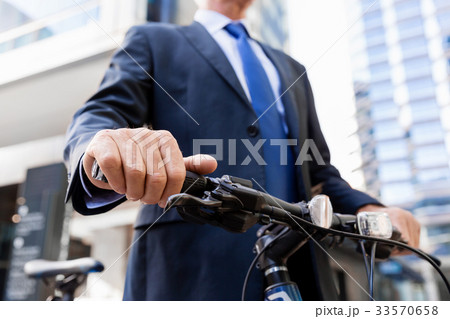 Successful businessman riding bicycle 33570658