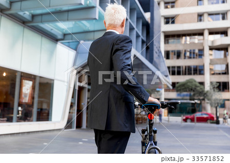 Successful businessman riding bicycle 33571852