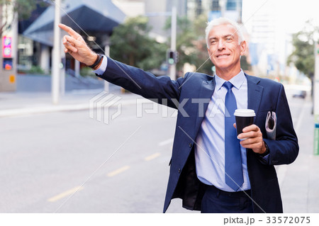 Businessman catching taxi in city 33572075