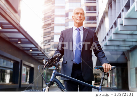 Successful businessman riding bicycle 33572331