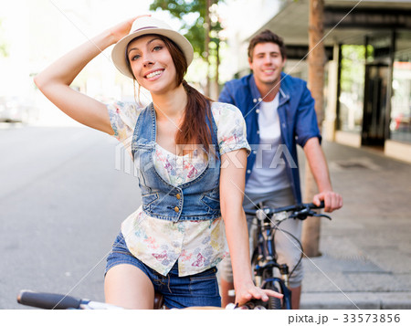 Happy couple in city with bike 33573856