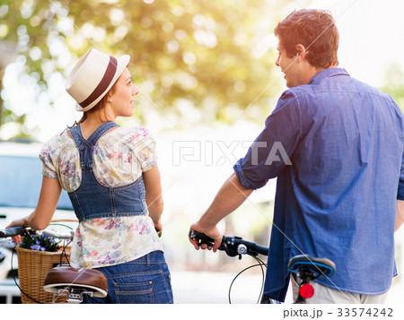 Happy couple in city with bike 33574242