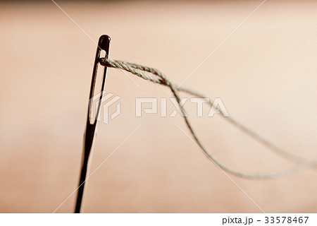 Detail of a Needle with Thread in the Workroom. 33578467