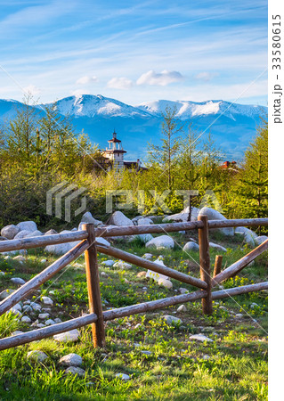 Spring landscape wooden fence, snowy mountain peak Spring landscape wooden fence, snowy mountain peak 33580615