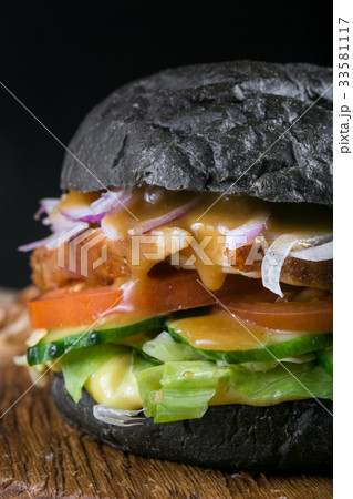 Fresh tasty burger on black background. Homemade 33581117