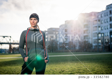 Determined young woman daydreaming while holding a 33582780