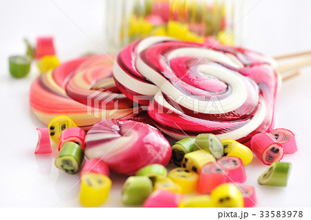 Colorful candies and lollipops on white background 33583978