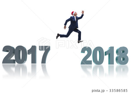 Businessman in santa hat jumping from 2017 to 2018 Businessman in santa hat jumping from 2017 to 2018 33586585