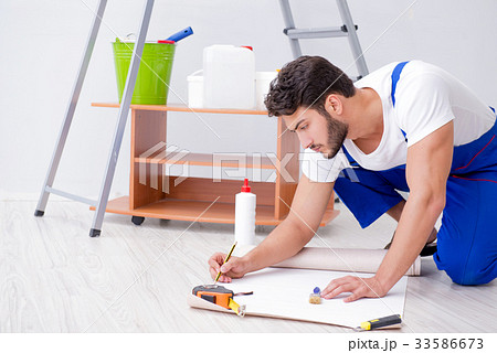 Repairman doing renovation repair in the house 33586673