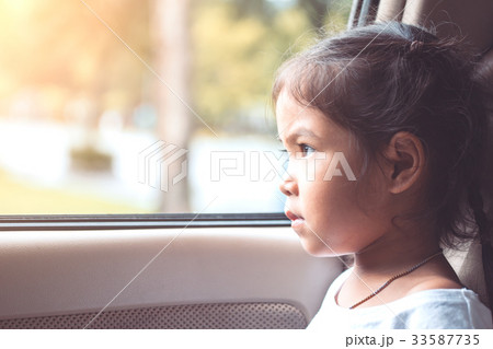 Cute asian little child girl sitting in the car Cute asian little child girl sitting in the car 33587735
