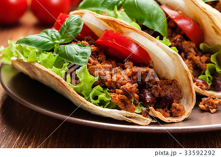Mexican tacos with minced meat, beans and spices 33592292
