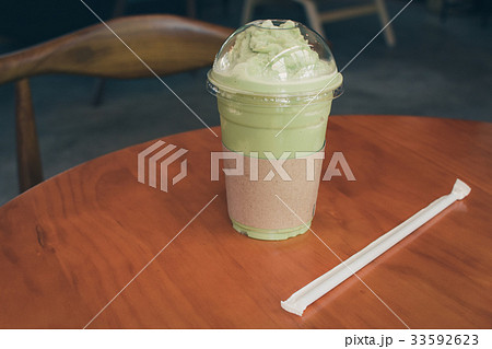 Iced Matcha latte tea on wooden table. 33592623