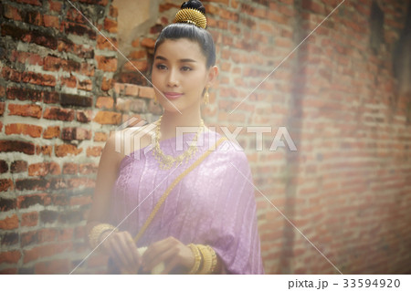 The picture of a beautiful woman smiling in the temple. The picture of a beautiful woman smiling in the temple. 33594920