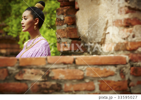 an asian young woman is walking in pagoda an asian young woman is walking in pagoda 33595027