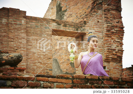 thai woman in traditional costume is holding flower garland in temple thai woman in traditional costume is holding flower garland in temple 33595028