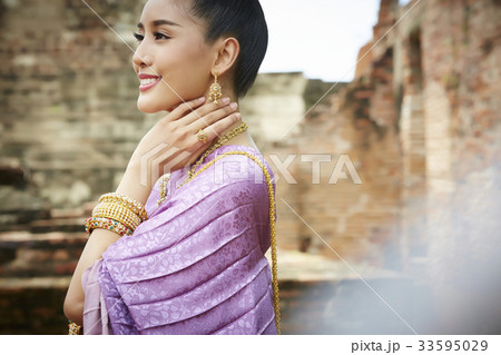 a portrait of happy woman in thai costume outdoors a portrait of happy woman in thai costume outdoors 33595029