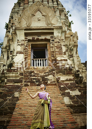 asian woman is standing in front of ancient monument 33595077