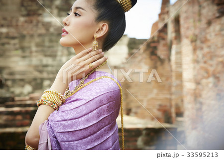 The portrait of a Thai woman putting hand on her neck 33595213