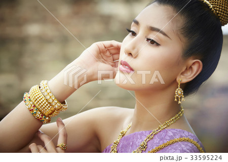 The portrait of Thai girl looking at something and thinking The portrait of Thai girl looking at something and thinking 33595224