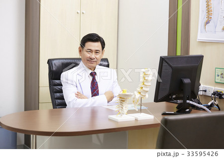 portrait of confident asian doctor sitting in office 33595426