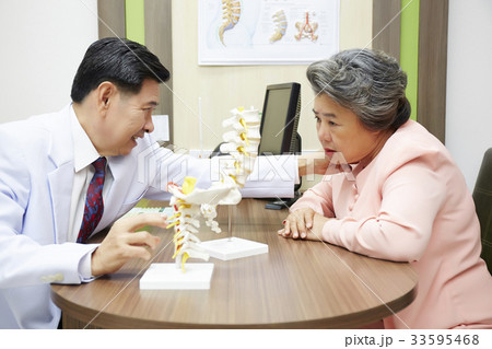 male doctor is examining elderly patient in clinic 33595468