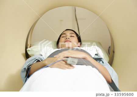 a photo of a woman lying and checking in the hospital 33595600