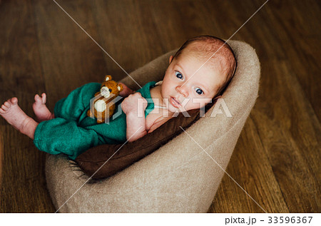 cute newborn looks surprised at the camera
 33596367