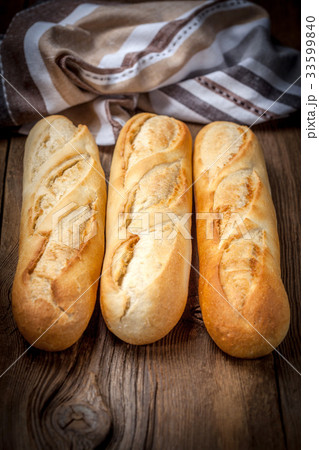 French baguettes on old wooden table. 33599840