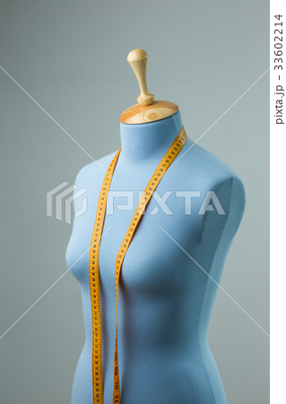 Blue tailor dummy with measuring tape alongside 33602214