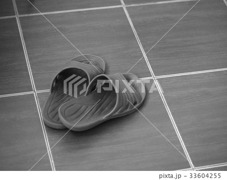 CLOSEUP OF RUBBER SANDAL ON FLOOR CLOSEUP OF RUBBER SANDAL ON FLOOR 33604255