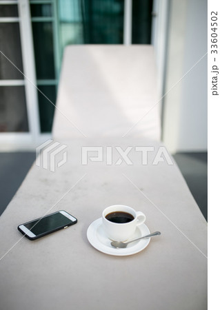 Coffee and MobilePhone on a Chair pool in resort 33604502