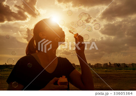 A South East Asian girl is blowing bubbles A South East Asian girl is blowing bubbles 33605364