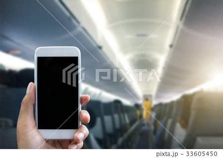 Man use your phone in airplane blurred background 33605450