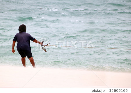 Fishermen with small boats in stormy weather. 33606166